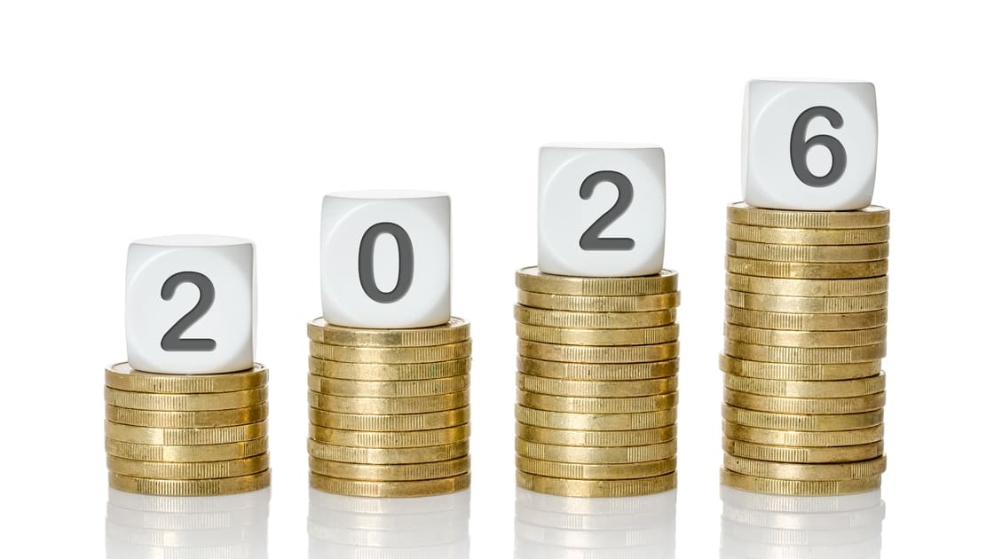 copertina dell'articolo sulla nuova legge di bilancio, una guida per le imprese nel 2026, con quattro pile di monete di altezza crescente con sopra i dadi che compongono l'anno 2026